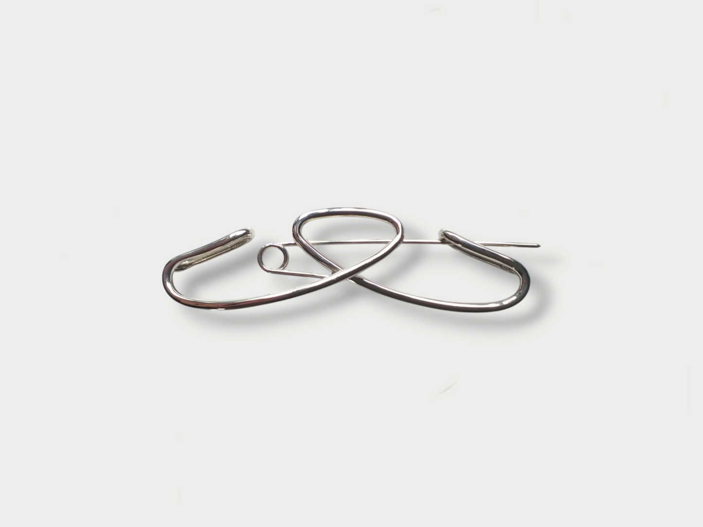 Anthony Was Here silver brooch with a simple art deco' inspired design on a white background