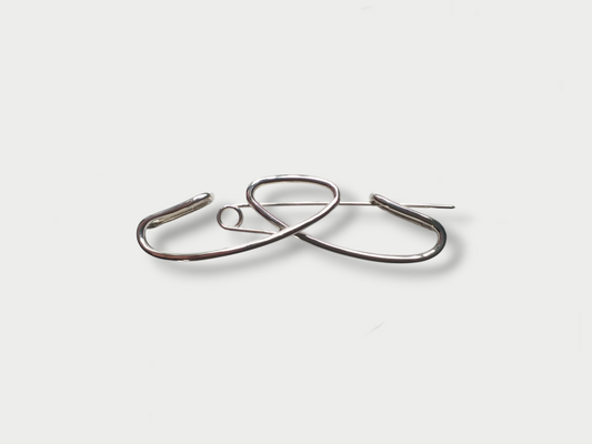 Anthony Was Here silver brooch with a simple art deco' inspired design on a white background