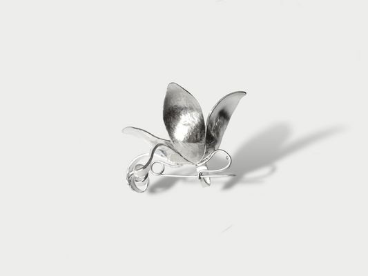 Side view of a silver (925) three-dimensional flower brooch against a white background.