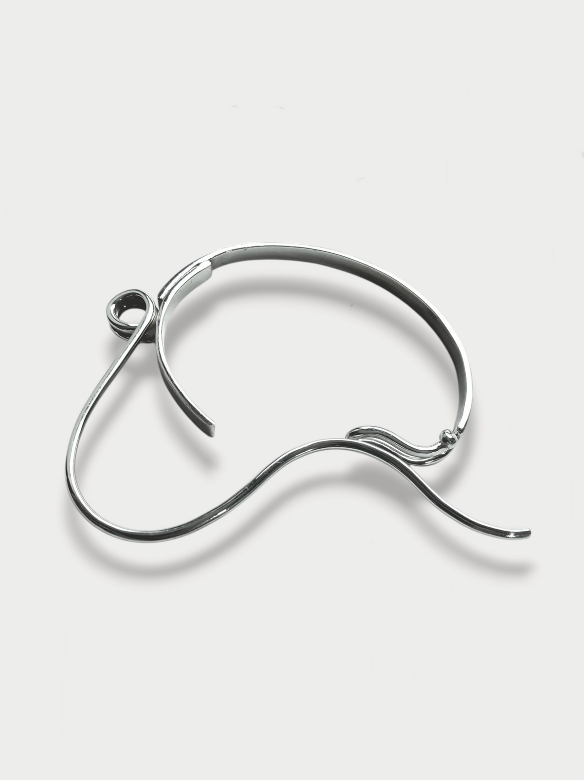 Anthony Was Here Experimental safety pin inspired silver bracelet on light background