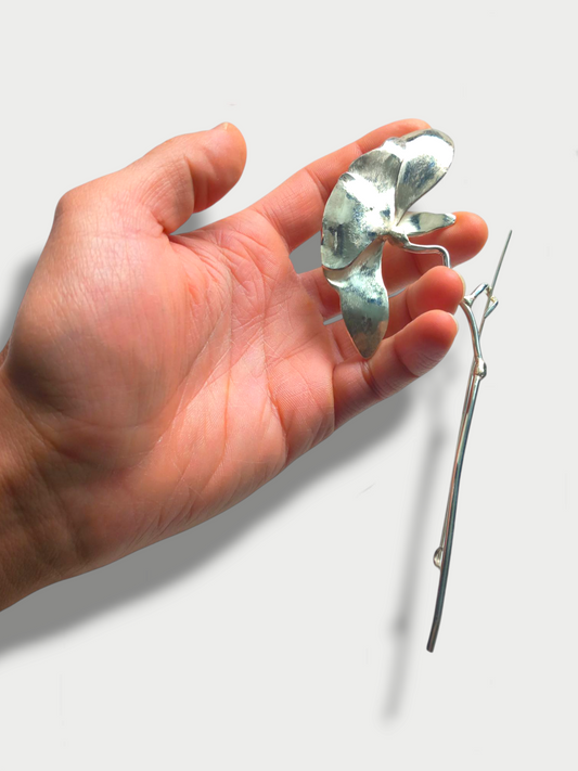 Detailed 925 silver peony flower brooch held in hand to show size and scale