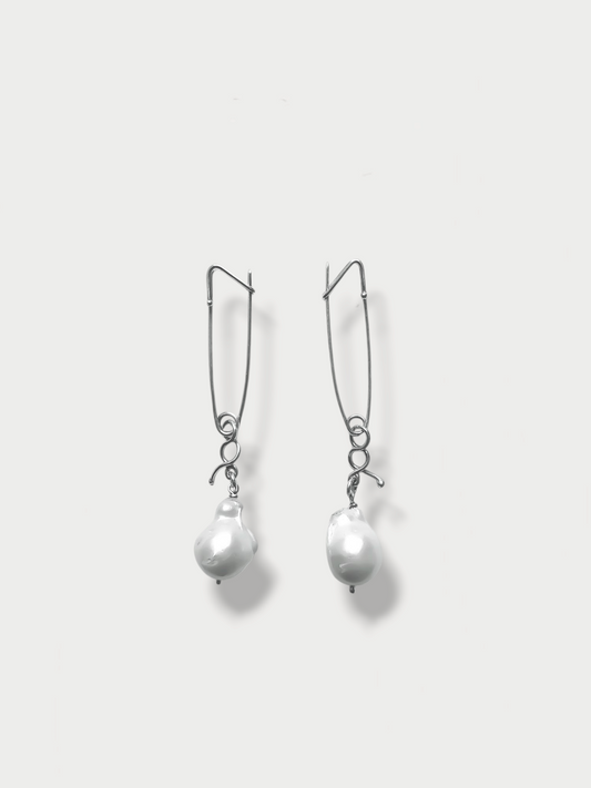 Anthony Was Here pair of silver safety pin cufflinks with pearl drop attachments, displayed against a white background.