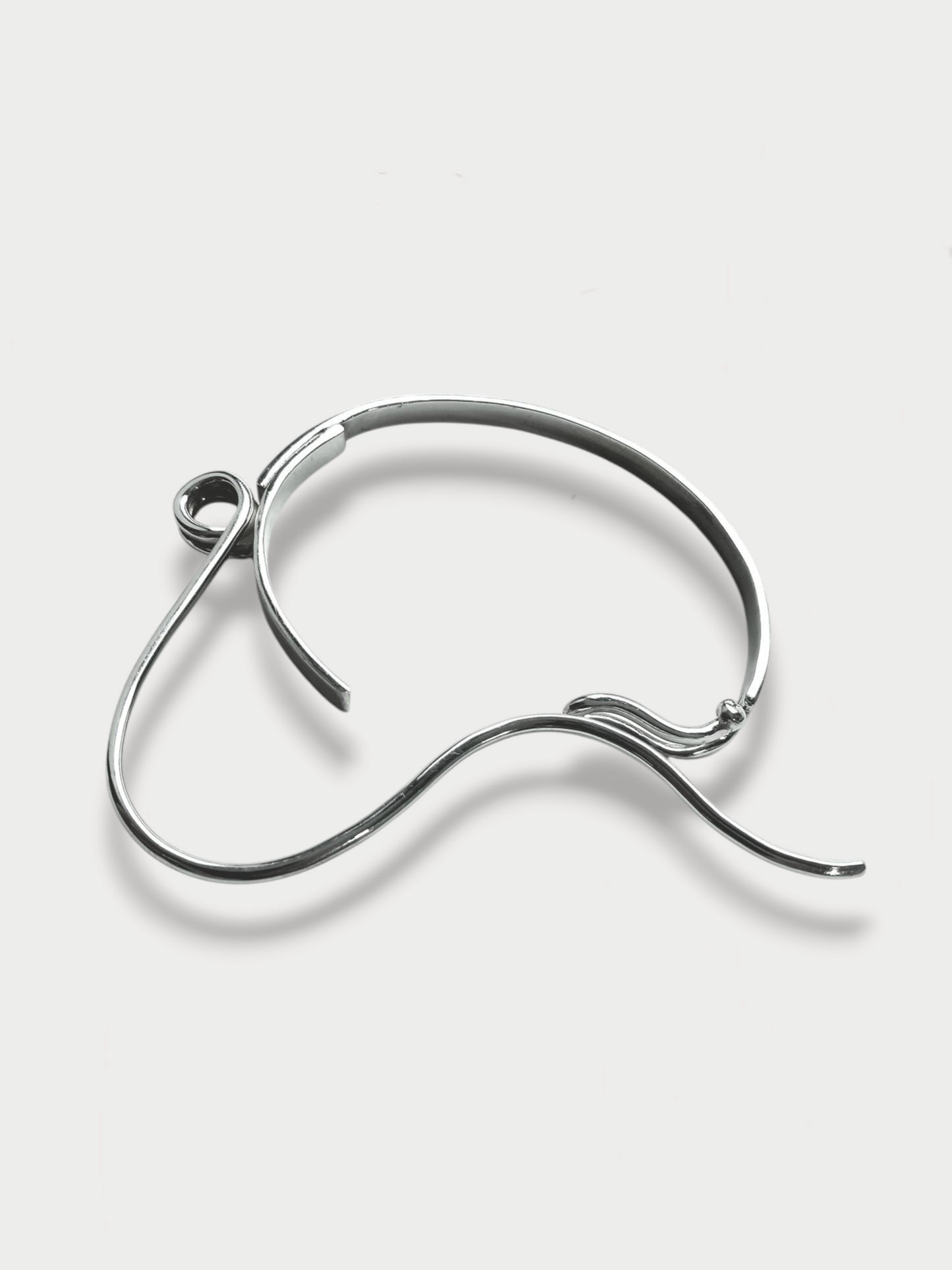 Anthony Was Here Experimental safety pin inspired silver bracelet on light background