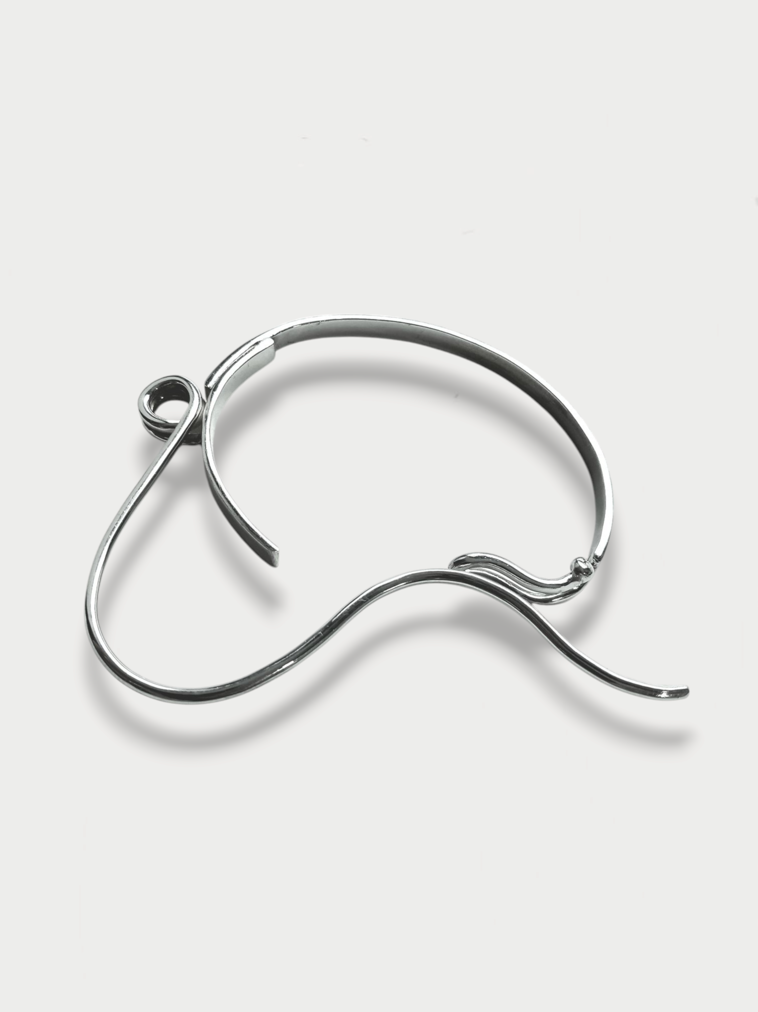 Anthony Was Here Experimental safety pin inspired silver bracelet on light background