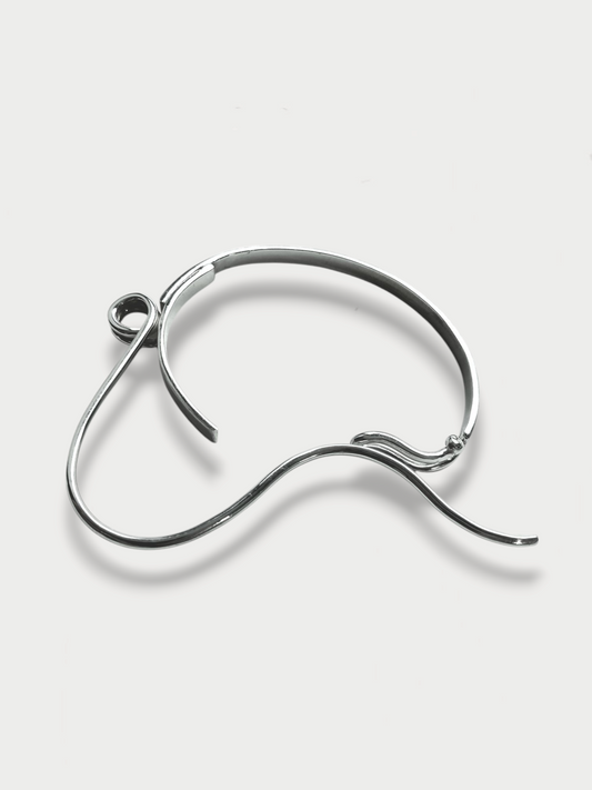 Anthony Was Here Experimental safety pin inspired silver bracelet on light background