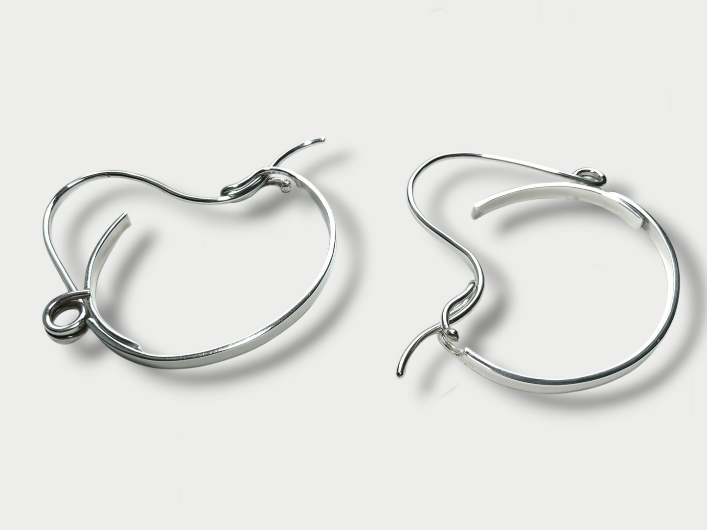 Anthony Was Here pair of Experimental sterling silver safety pin bracelets showing angle and closure details