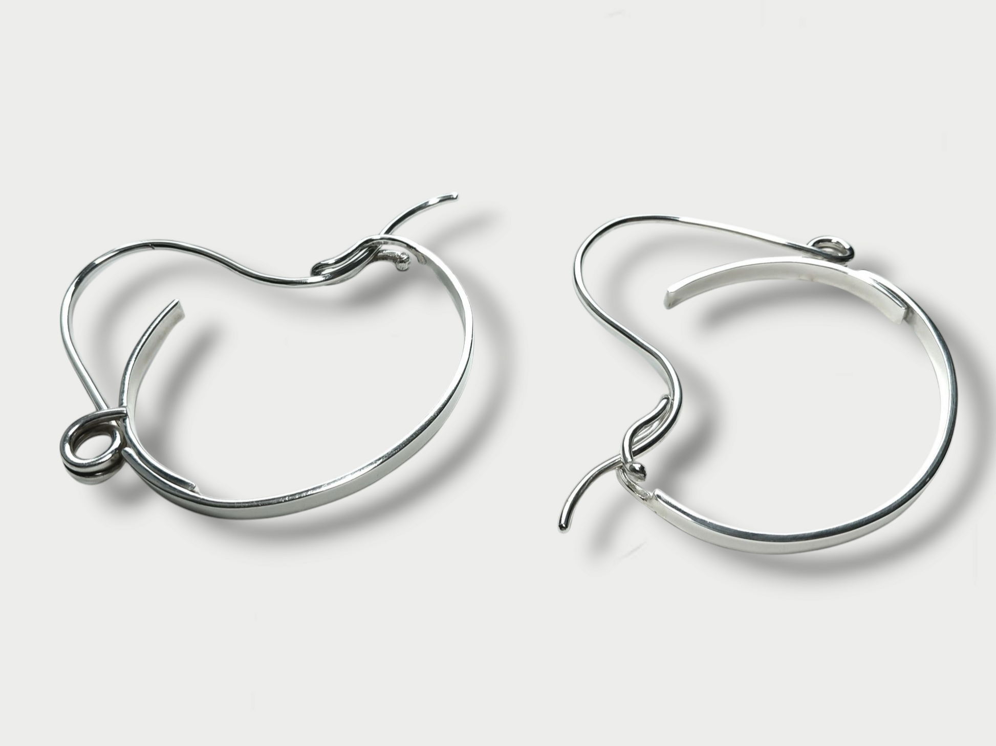 Anthony Was Here pair of Experimental sterling silver safety pin bracelets showing angle and closure details
