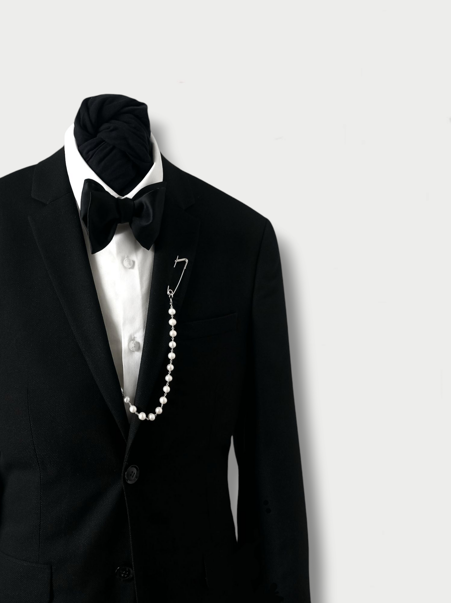 styling example of a silver and pearls pin combination on a blazer